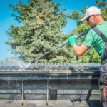 Professional pressure washing service cleaning a residential roof exterior
