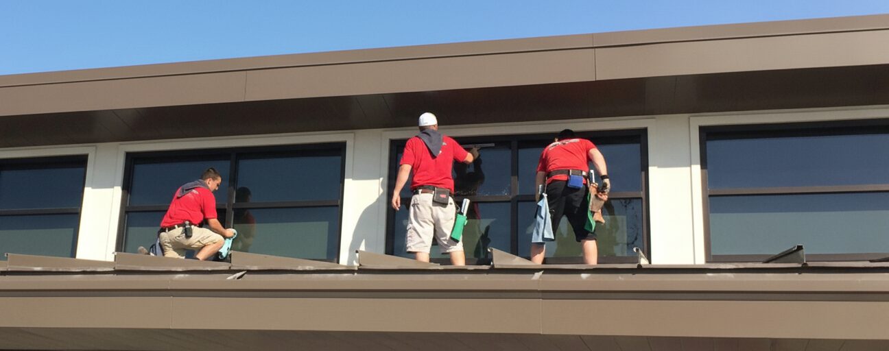 Enlightened Views crew cleaning commercial windows from a rooftop